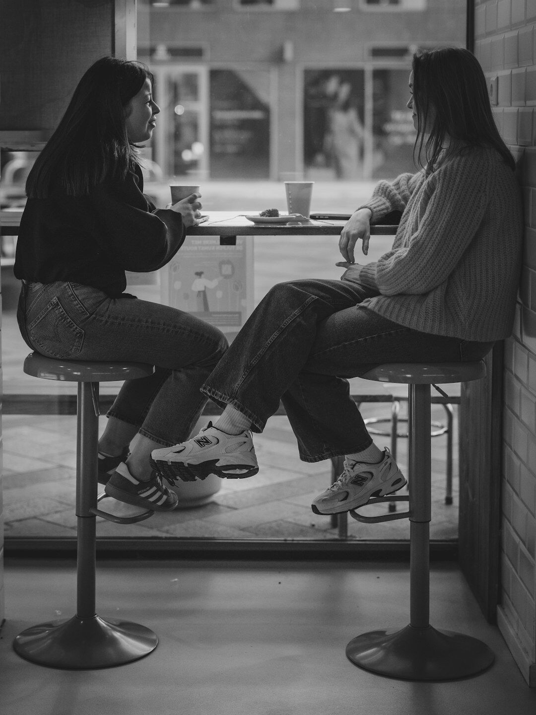 Journalist interviewing a source at a café table