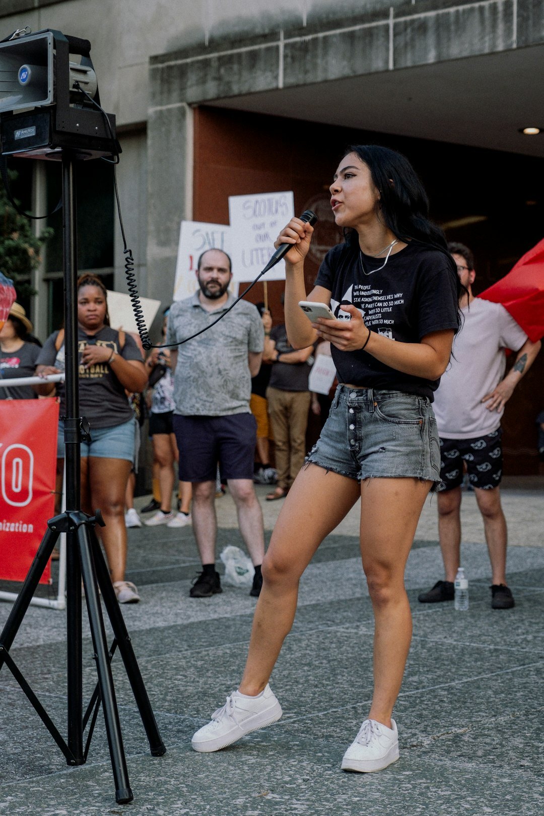 Field reporter covering a live outdoor event with a microphone