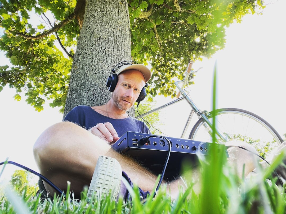 Radio journalist recording audio outdoors with a portable recorder